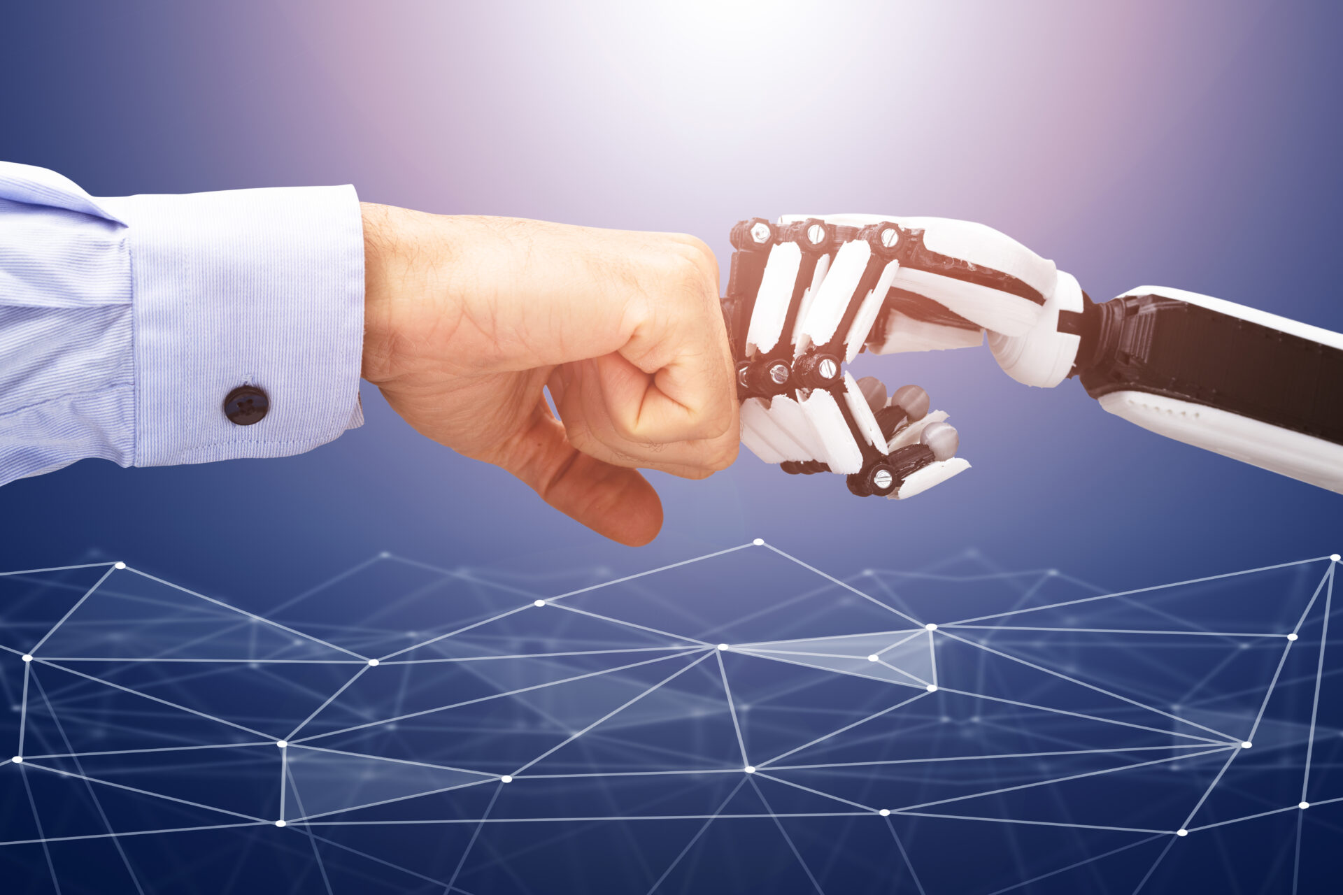 Robot And Businessman's Hand Making Fist Bump